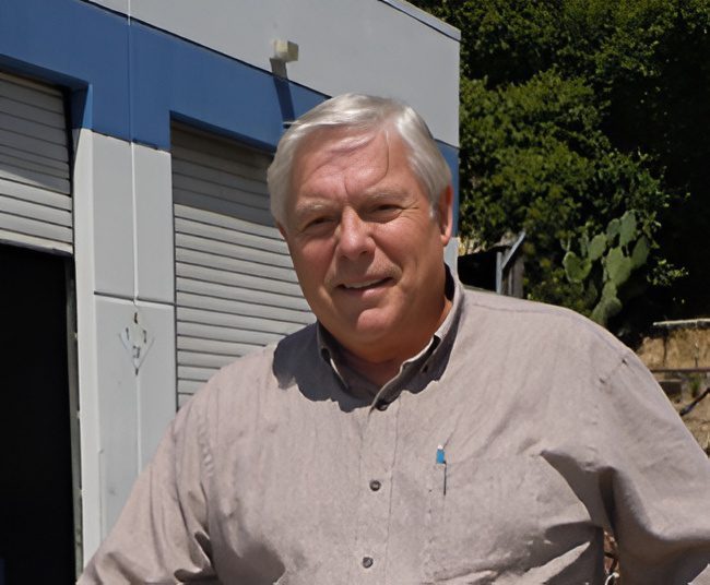 Man standing outdoors near a building.